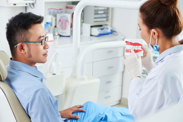 dentist explaining about lingual braces