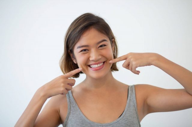 woman smiling with lingual braces