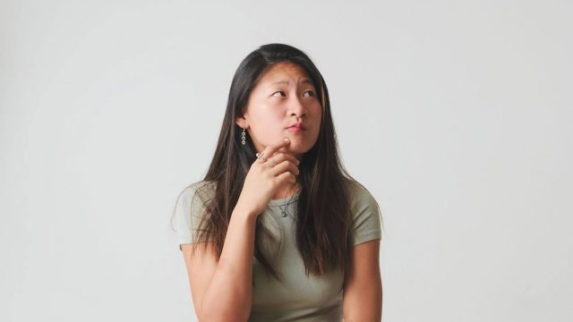 woman thinking about lingual braces advantages